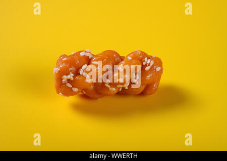 traditional Chinese twisted deep fried dough on yellow background Stock Photo