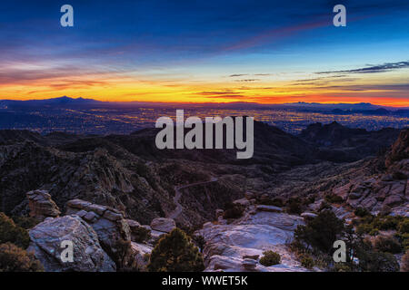 Sunset from the Catalina Mountains overlooking the city lights of Tucson, Arizona Stock Photo