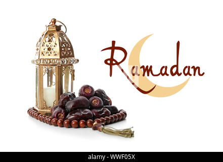 Muslim lamp, dates, tasbih and word RAMADAN on white background Stock Photo