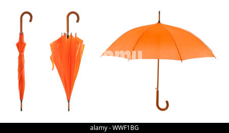 Stylish orange umbrellas on white background Stock Photo
