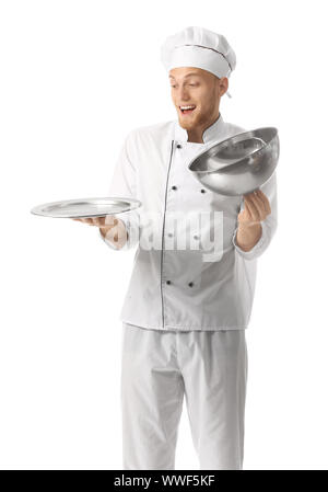 Surprised male chef with tray and cloche on white background Stock Photo