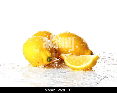 Ripe lemons with water splash on white background Stock Photo