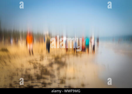Abstract background image of people walking on the beach in the style of the Impressionists. Soft focus. A blurring technique creates a unique impress Stock Photo