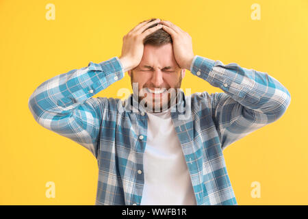 Man having panic attack on color background Stock Photo