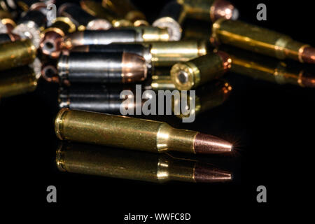 222 rifle ammunition with other miscellaneous bullets on black background Stock Photo