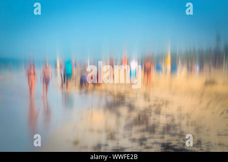 Abstract background image of people walking on the beach in the style of the Impressionists. Soft focus. A blurring technique creates a unique impress Stock Photo