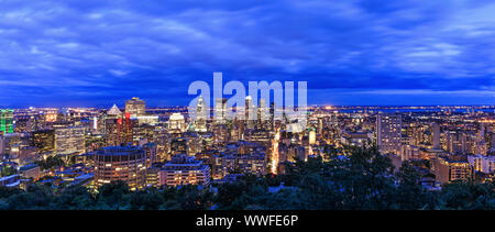 Montreal view at sunrise or sunset time with blue sky. Panoramic skyline of Canadian city. Beautiful night clouds over Montreal downtown buildings. Stock Photo