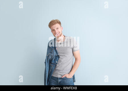 Man in stylish t-shirt on color background Stock Photo