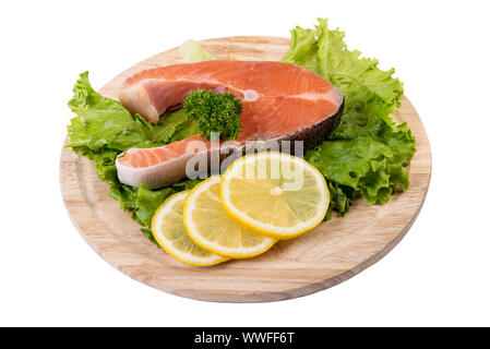 Raw salmon steak on the wooden board isolated on white with clipping path Stock Photo