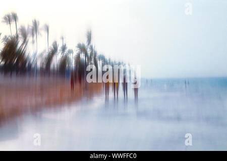 Abstract background image of people walking on the beach in the style of the Impressionists. Soft focus. A blurring technique creates a unique impress Stock Photo