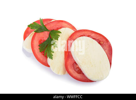 Piece of mozzarella Buffalo with cherry tomato at white background. Decorated with parsley herb. Clipping path Stock Photo