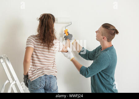 Happy young couple doing repair in their new house Stock Photo