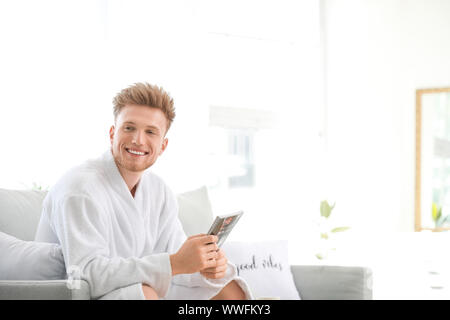 Morning of young man reading magazine at home Stock Photo