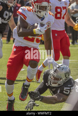 Kansas City Chiefs outside linebacker Tamba Hali (91) and Kansas City Chiefs  free safety Kendrick Lewis (23) combine to tackle Buffalo Bills running  back C.J. Spiller (28) in the third quarter at