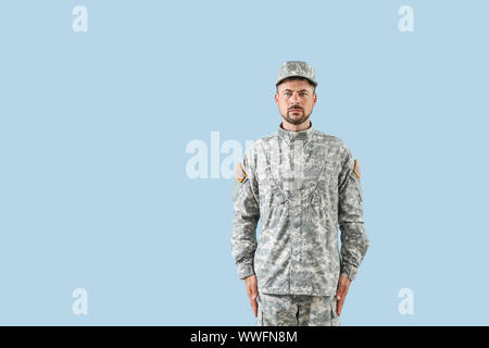 Soldier in camouflage on color background Stock Photo
