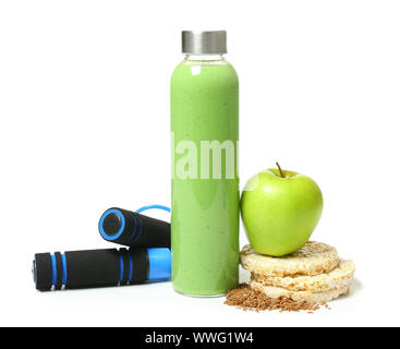 Bottle of healthy smoothie with food and jumping rope on white background Stock Photo
