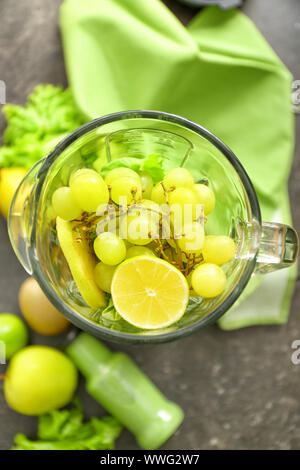 Blender with ingredients for healthy smoothie on dark table Stock Photo