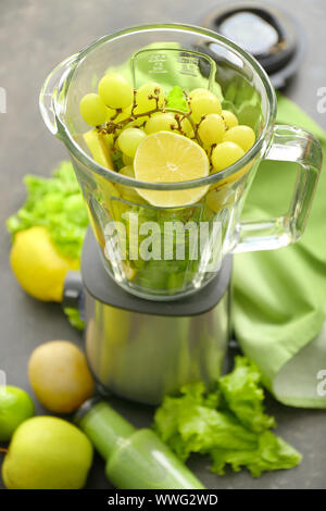 Blender with ingredients for healthy smoothie on dark table Stock Photo