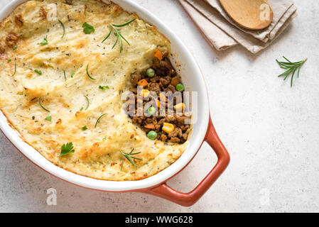 Shepherd's Pie with ground beef, potato and cheese on white background, top view, copy space. Traditional homemade casserole - Shepherds Pie. Stock Photo