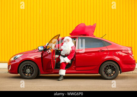 Santa Claus getting out of car outdoors Stock Photo