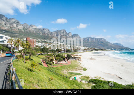 scenic view onto the upmarket suburb of Camps Bay in Cape Town, South Africa with its white sandy blue flag beach and the Twelve Apostle mountains Stock Photo