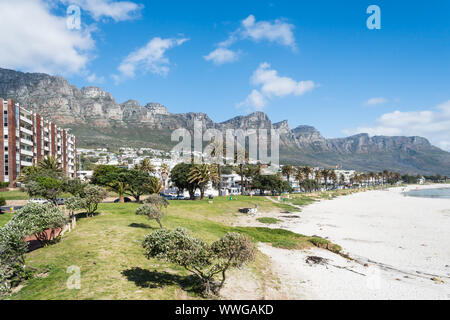 Camps Bay white sandy blue flag beach in Cape Town, South Africa scenic view onto the upmarket suburb with Twelve Apostle mountains in the background Stock Photo