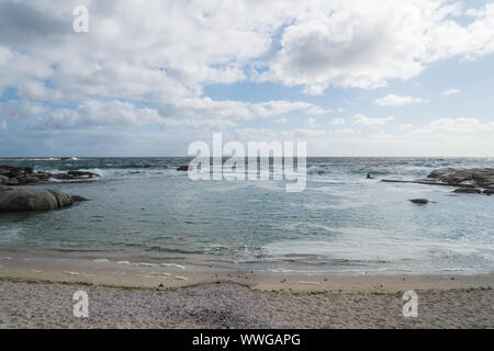 coastal tidal or tide pool at a white sandy beach on a cloudy Spring day in Camps Bay, Cape Town, South Africa with no people Stock Photo