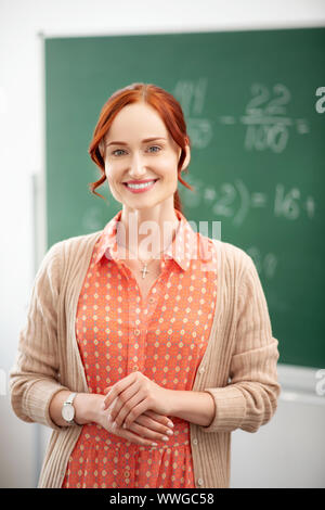 Beaming teacher smiling before the start of school year Stock Photo