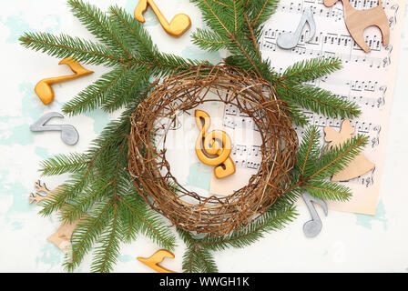 Composition with note sheets and Christmas decor on light background Stock Photo