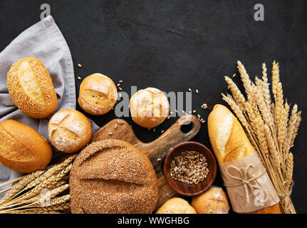Assortment of baked bread on black concrete  background Stock Photo
