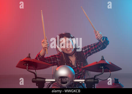 Music, electronic drum set and hobby concept - woman drummer in a recording studio Stock Photo