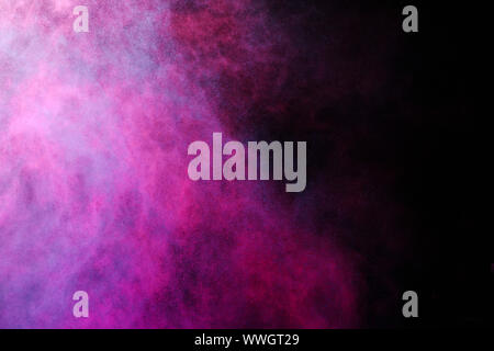 Freeze motion of colored dust explosion isolated on black background. Stock Photo