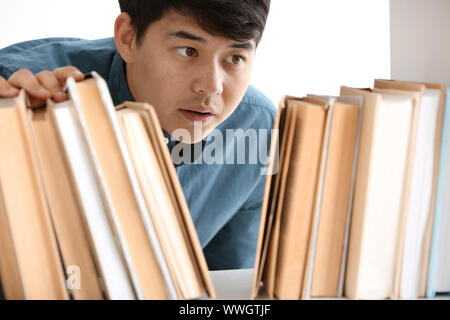 Asian student choosing book in library Stock Photo