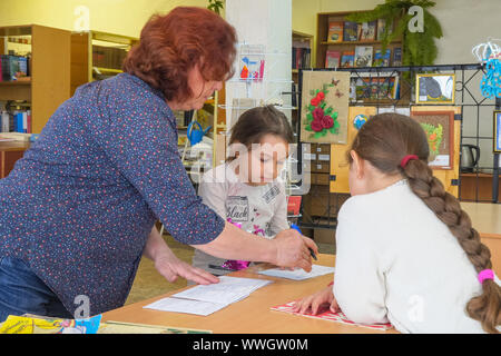 Chapaevsk, Samara region, Russia - May 10, 2019: Elementary school. Woman Teacher with primary school students. School children are standing next to t Stock Photo