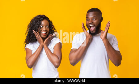 Shocked african american couple looking at each other Stock Photo