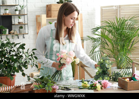 Female florist making beautiful bouquet at flower shop Stock Photo - Alamy