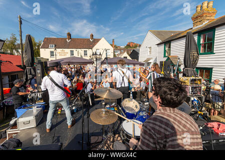 Rock band playing at the Old Leigh Regatta 2019 in Old Leigh, Leigh on Sea, Essex, UK. Crooked Billet pub and large crowd on a sunny day Stock Photo