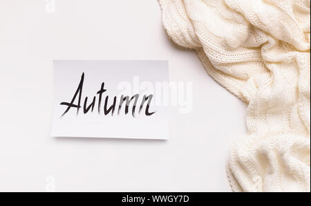 Creative autumn background with white wool scarf Stock Photo