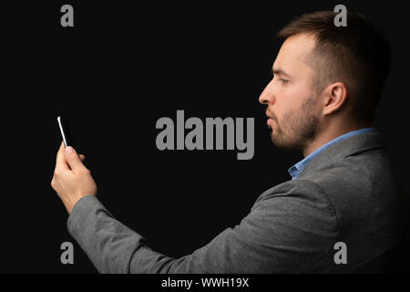 Modern businessman using facial recognition softwear on cellphone Stock Photo