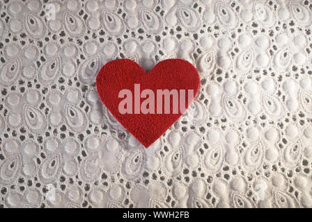 Retro Love. White fabric and red heart shape conceptual composition. Macro texture close up useful as background for design works. Stock Photo