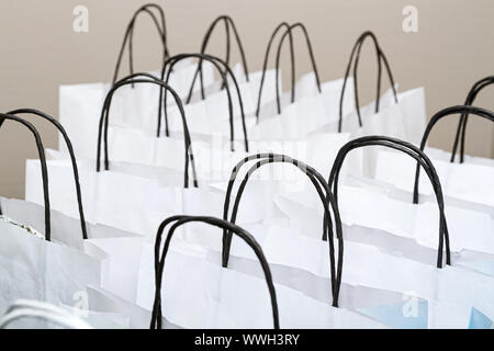 White paper shopping bags with black handles, closeup shot Stock Photo
