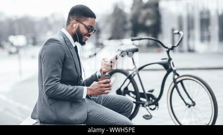 Handsome businessman browsing net during coffee break Stock Photo
