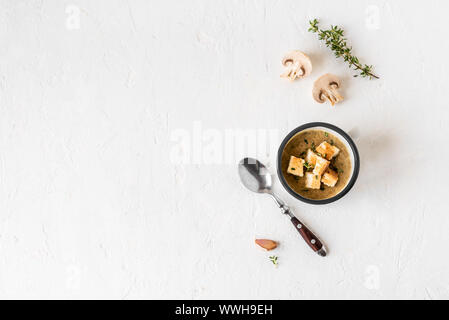 Mushroom Soup. Homemade champignons cream soup with croutons in enamel mug. Healthy and comfort food concept, copy space. Stock Photo