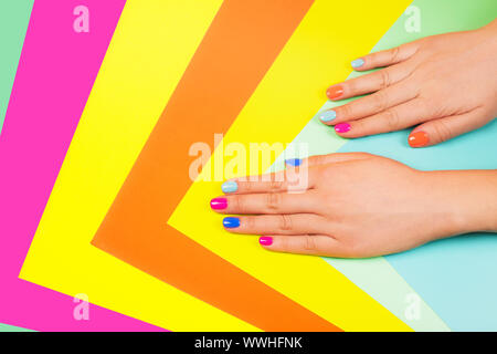 Neon manicure on multicolored bright background in trendy colors. Flat lay style. Stock Photo