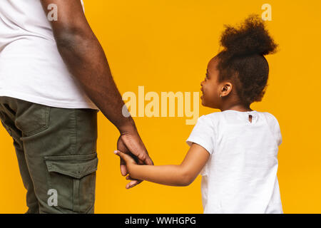 African father and little daughter holding hands Stock Photo