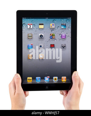 Kiev, Ukraine - December 03, 2011 - Woman hands holding Apple iPad2 with homepage on a screen. This second generation Ipad 2 is designed and developme Stock Photo