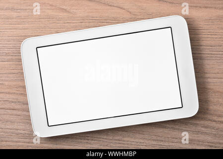 White tablet with white screen on wood table close up. Horizontal composition. Top view Stock Photo