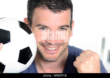 closeup of passionate soccer player with white and black balloon Stock Photo