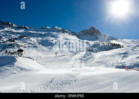 Fresh ski slope with snowcat tracks in Meribel Valley, French Alps Stock Photo