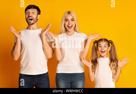 Happy Parents And Daughter Shouting Celebrating Success In Studio Stock Photo